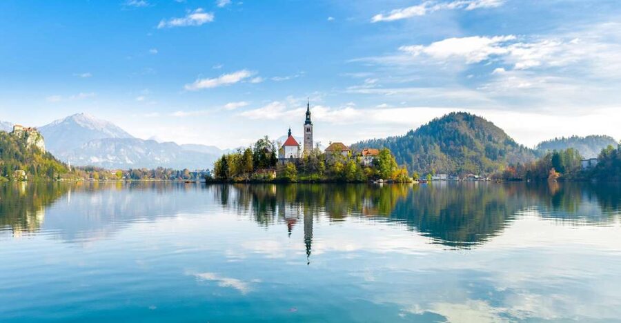 From Ljubljana: Lake Bled & Postojna Cave with Entry Tickets - Predjama Castle inside a cave, Erasmus stories, and rural views